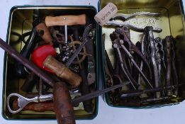 A collection of assorted vintage corkscrews along with a collection of nutcrackers.