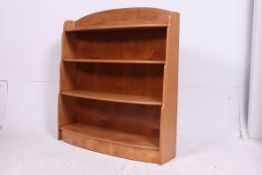 A good quality 20th century beech wood bow front open window bookcase cabinet having central