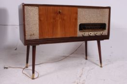 A retro 1950's stereogram by Fidelity in teak with grill front and hinged top having inset deck and