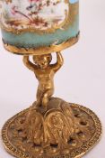 A 19th century continental Sevres ceramic and gilded metal goblet.
