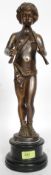 A late 19th / early 20th century bronze statue of a piper cherub, mounted on a circular marble base.
