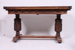 A stunning Jacobean revival carved oak draw leaf extending refectory dining table made of heavy