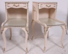 A pair of 20th century Louis style painted rococo matching bedside cabinet tables.
