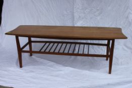 A 1970's Danish Influence teak wood rectangular coffee table raised on squared legs with slatted