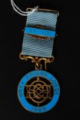 A Masonic gilded silver and enamel set medal and ribbon with notation for Grey Friars Lodge 1866.
