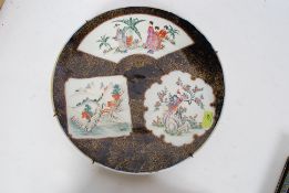 A large chinese polychrome wall charger having sectional geometric design with scenes of people and