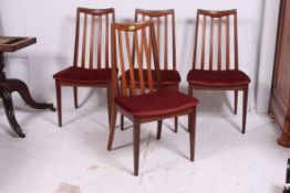 A set of 4 1970's G-Plan teak wood dining chairs raised on squared tapered supports with original