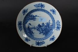 An 18th century Chinese blue and white plate with a willow pattern design to the centre having
