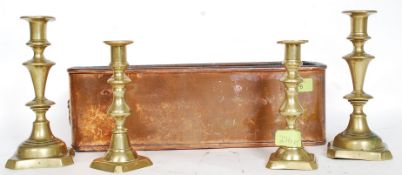 A vintage copper planter along with two pairs of brass candle sticks.