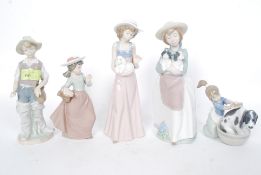 NAO / LLADRO; A collection of 5x assorted Nao / Lladro porcelain figurines to include a boy,