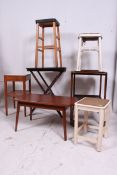 A mahogany table together with a side table, folding table, 2 stools and a serving trolley.