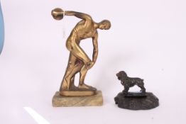 A spelter figurine of a spaniel over base together with a cast metal figurine of a discus thrower
