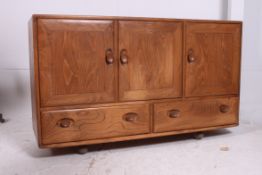 An original Ercol Windsor pattern elm wood low sideboard dresser.