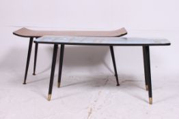 A retro pictorial 1950's coffee table raised on tapered legs together with a similar tapered leg