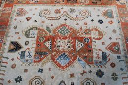 A large fine quality Persian style rug having central cream ground with medallion and red marble to