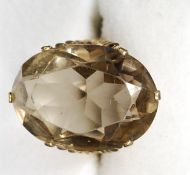 A 9ct gold ( tested ) and large Citrine set ladies dress ring having oversized fret worked mount to