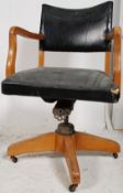 A retro 1950's vintage Industrial office swivel desk chair having show wood frame with black faux