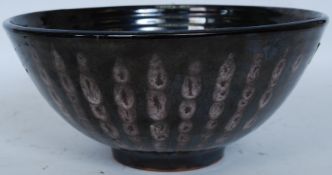 A Dennis Lucas studio pottery lustre glaze large fruit bowl having impressed double fish mark to