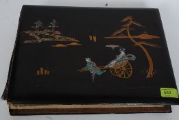 An early 20thC Japanese black lacquered postcard album,