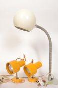 A 1970's retro golf ball anglepoise desk lamp together with a pair of 1970's yellow wall mounted