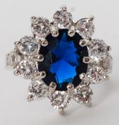 A ladies silver 925 ring set with a blue sapphire? stone having decorative surround. Weight 6.1g.