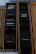 An excellent collection of vintage glass negative plate photograph slides set within 2 wooden box.