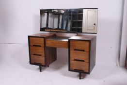 A retro 20th century Stag Mid C range  dressing table chest of drawers being raised on shaped