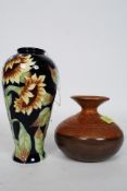 A tube lined design vase decorated with Sunflowers on a cobalt blue background bearing marks to