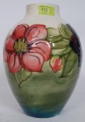 A Moorcroft baluster vase decorated in the Clematis pattern on a yellow and green ground,