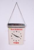 A vintage 20th century 1960's ' Guinness Time ' hanging time clock, with notation to the dial.
