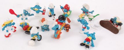 SMURFS; A collection of vintage plastic Smurfs figures by Peyo including cycling smurf,