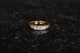 An 18ct gold and five stone diamond ring