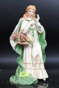 A ceramic figure of a maiden entitled 'T