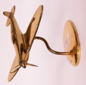 An apprentice piece / Trench Art made from brass in the form of a Spitfire being elevated on a