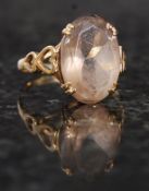 A 9ct gold ladies cocktail dress ring with large citrine stone set to pierced heart shaped shank.