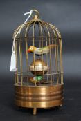 An antique style automaton brass cased clock in the form of a bird cage