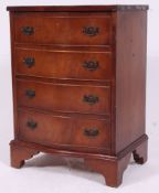 A Georgian style mahogany bachelors chest of drawers raised on bracket feet with short and deep