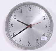 A vintage electric commercial wall clock by Blick having metal case