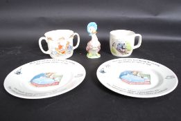 A bunnykins twin handled loving cup together with a series plates,