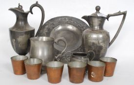 A collection of pewter and Britannia metal items to include jugs, beakers,
