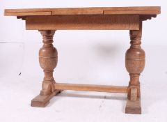 A 1930's oak draw leaf refectory dining table.
