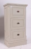 A 20th century shabby chic painted pedestal chest of drawers raised on a plinth base with bank of