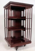 An excellent mahogany large revolving bookcase having slatted sides with inset silver plaque to the