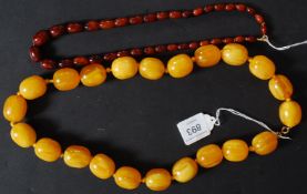 A stunning large beaded butterscotch amber necklace having a gold metal clasp along with another