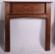 A good quality 1930's Art Deco style oak fireplace surround having embellished central panel with