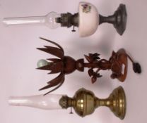 Two 20th century oil lamps with shades along with a mid 20th century wooden metamorphic electric