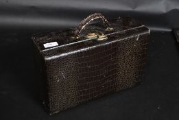 A vintage faux crocodile skin vanity case along with a similar faux lizard skin purse / handbag
