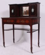 An Edwardian mahogany inlaid bonheur de jour, standing on tapered legs on brass castors.