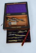 An early 20th century cased geometry drawing set together with a 14k nib Parker fountain pen.