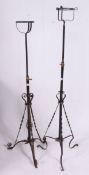 A near pair of early 20th century cast iron rococo oil lamp stands.